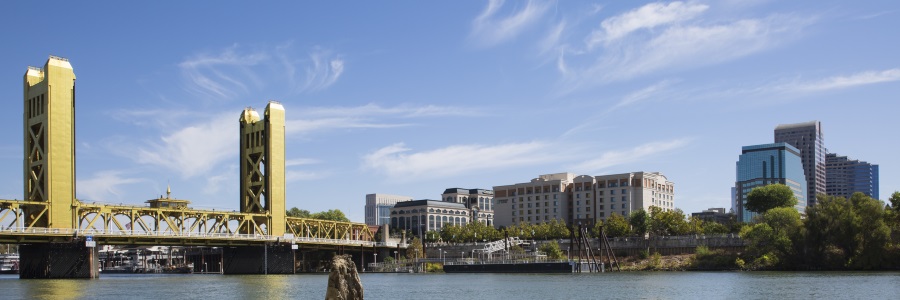 The skyline of Sacramento, California with the grand, golden tower bridge featured prominently.